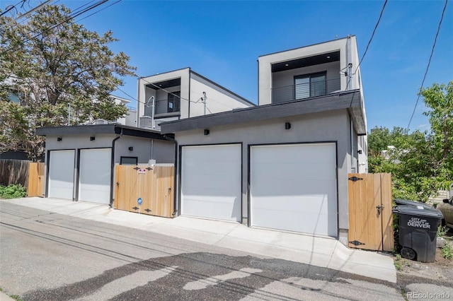 1715 Grove St, Denver, CO 80204 - view of front facade with a balcony, stucco siding, and a garage