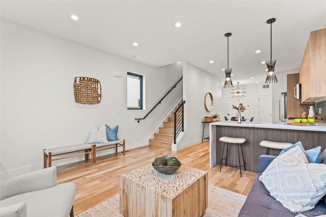 1715 Grove St, Denver, CO 80204 - living area featuring stairs, light wood finished floors, recessed lighting, and baseboards