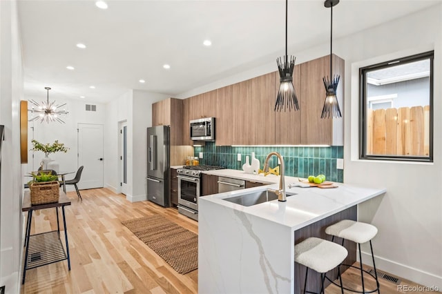 1715 Grove St, Denver, CO 80204 - kitchen featuring high quality appliances, a sink, baseboards, decorative backsplash, and recessed lighting