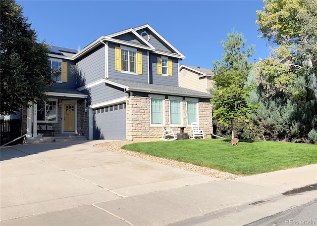 craftsman inspired home featuring solar panels, a front yard, and a garage