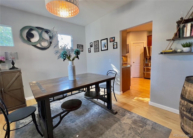 dining room with a wealth of natural light and light hardwood / wood-style flooring