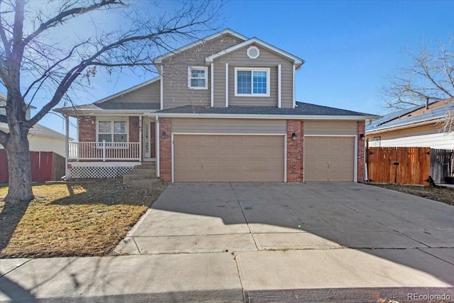 view of property featuring a garage and covered porch