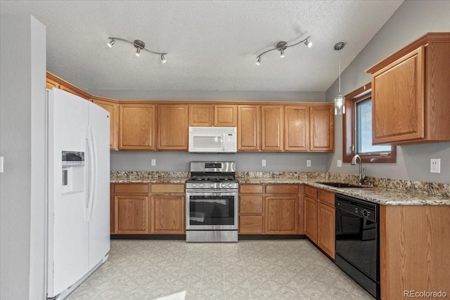 kitchen with light stone counters, white appliances, sink, and hanging light fixtures