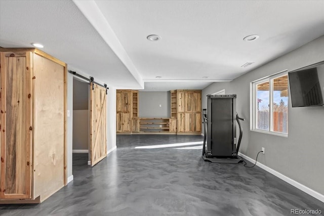 workout area with a barn door and built in shelves