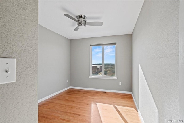 unfurnished room featuring hardwood / wood-style flooring and ceiling fan