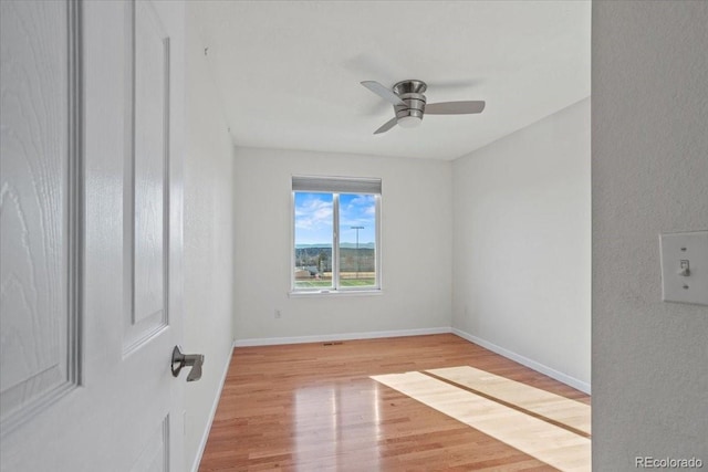 unfurnished room with light hardwood / wood-style flooring and ceiling fan