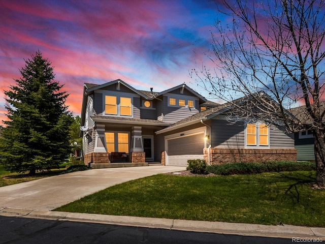 view of front of property featuring brick siding, a garage, a front lawn, and concrete driveway