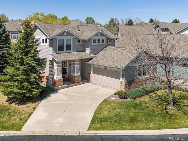 craftsman-style house featuring a garage, driveway, board and batten siding, and roof with shingles