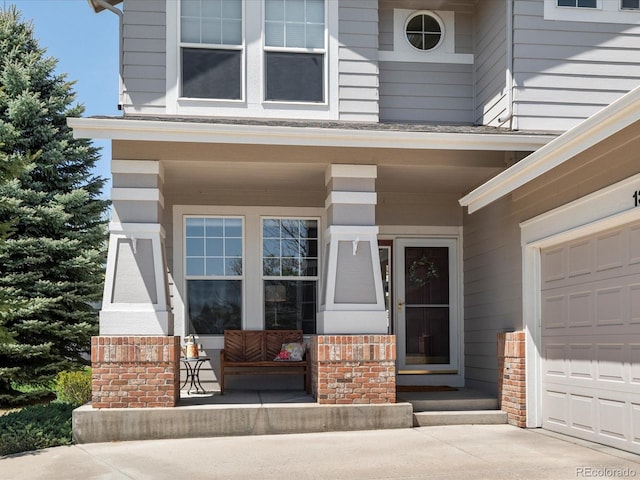 entrance to property with covered porch and brick siding