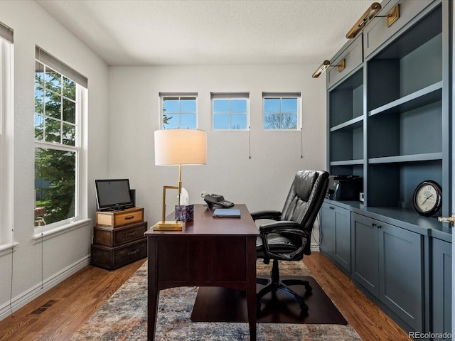home office featuring dark wood-style floors and baseboards