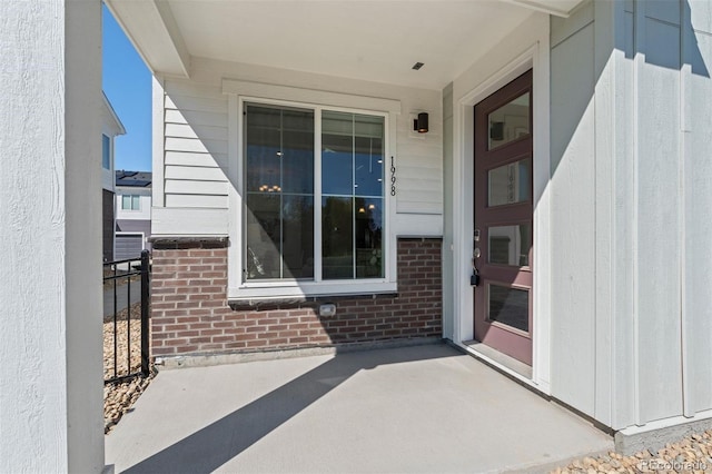 property entrance with brick siding