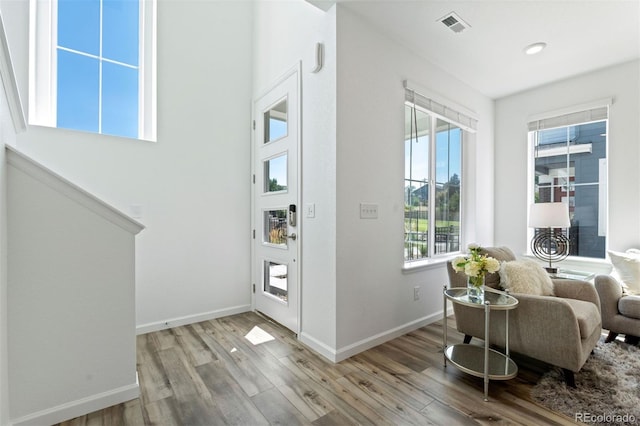 interior space with light wood finished floors, visible vents, and baseboards