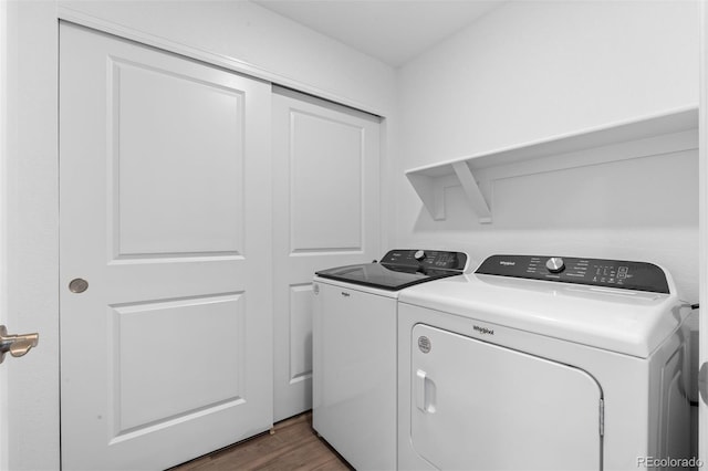 laundry area with dark wood-style floors, laundry area, and washing machine and clothes dryer