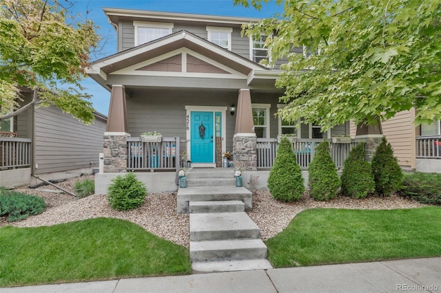 4578 Quandary Peak St, Brighton, CO 80601 - view of front of property featuring covered porch and stone siding