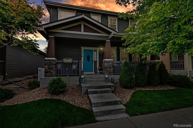 4578 Quandary Peak St, Brighton, CO 80601 - craftsman-style house featuring a porch and stone siding