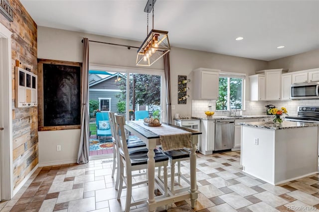 4578 Quandary Peak St, Brighton, CO 80601 - kitchen featuring stainless steel appliances, light stone countertops, backsplash, white cabinets, and recessed lighting