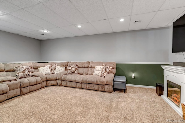 4578 Quandary Peak St, Brighton, CO 80601 - carpeted living area featuring recessed lighting, a glass covered fireplace, baseboards, and a paneled ceiling