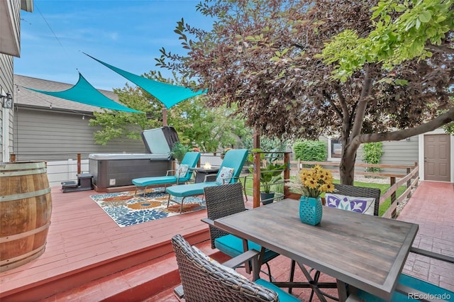 4578 Quandary Peak St, Brighton, CO 80601 - wooden terrace with a hot tub, outdoor dining area, and a storage unit