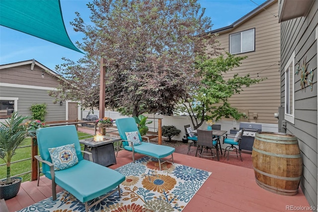 4578 Quandary Peak St, Brighton, CO 80601 - view of patio / terrace with an outdoor fire pit, a grill, outdoor dining space, and a wooden deck