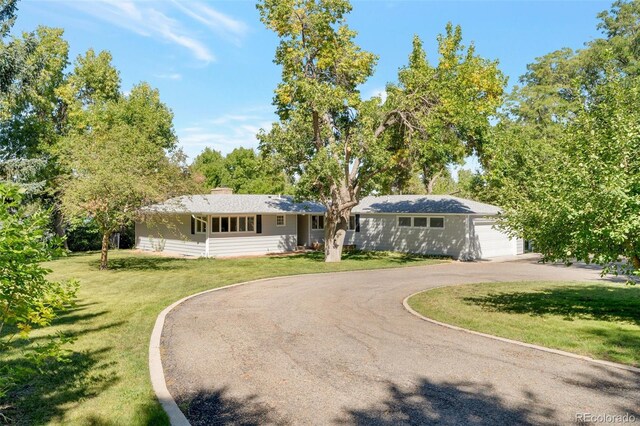 8813 Baseline Rd, Lafayette, CO 80026 - single story home with driveway, a front lawn, an attached garage, and a chimney