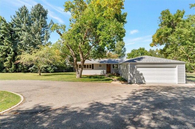 8813 Baseline Rd, Lafayette, CO 80026 - ranch-style home with asphalt driveway, a front lawn, and an attached garage