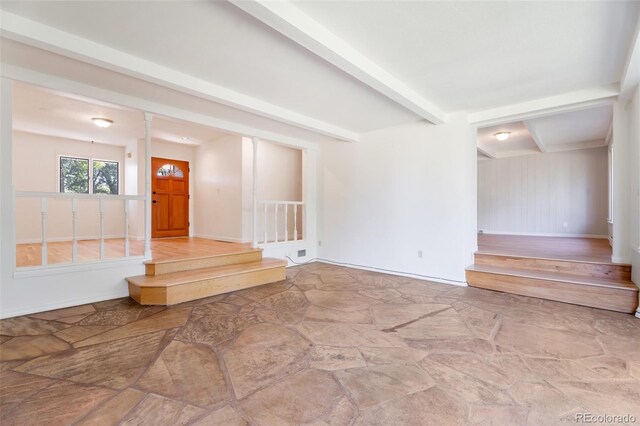 8813 Baseline Rd, Lafayette, CO 80026 - foyer featuring stone floors, beamed ceiling, stairway, and baseboards