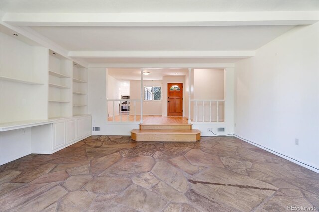 8813 Baseline Rd, Lafayette, CO 80026 - unfurnished living room with stone floors and beamed ceiling
