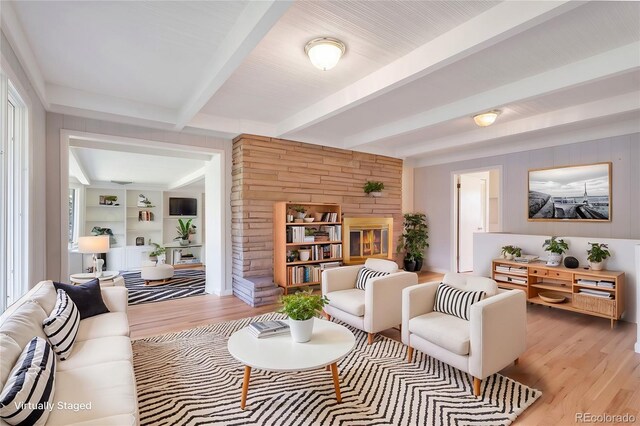 8813 Baseline Rd, Lafayette, CO 80026 - living area featuring light wood-style flooring, beamed ceiling, and wood walls