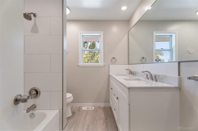 8813 Baseline Rd, Lafayette, CO 80026 - full bath featuring toilet, wood finished floors, plenty of natural light, and double vanity