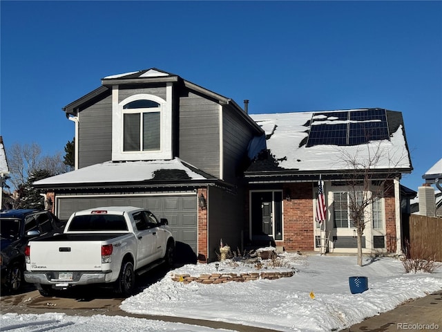 view of front of home with solar panels and a garage