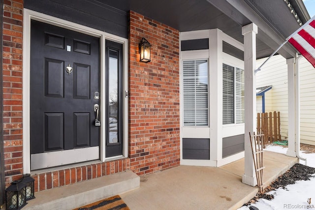 view of snow covered property entrance