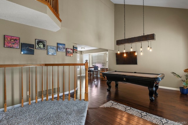 playroom with a towering ceiling, hardwood / wood-style floors, and pool table