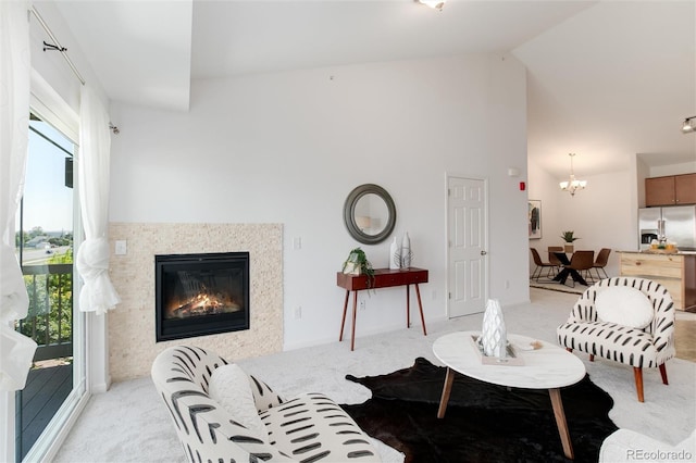 804 Summer Hawk Dr Unit 7301, Longmont, CO 80504 - living area with light carpet, a glass covered fireplace, a wealth of natural light, and a notable chandelier