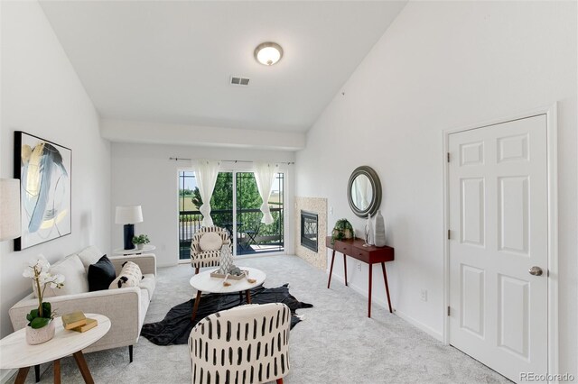 804 Summer Hawk Dr Unit 7301, Longmont, CO 80504 - living room with lofted ceiling, carpet flooring, visible vents, and a tiled fireplace