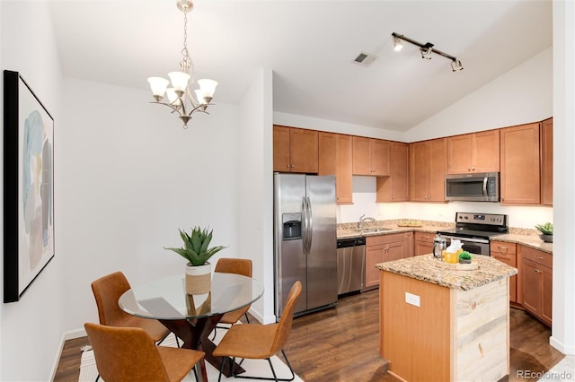 804 Summer Hawk Dr Unit 7301, Longmont, CO 80504 - kitchen with vaulted ceiling, a sink, an inviting chandelier, stainless steel appliances, and a kitchen island