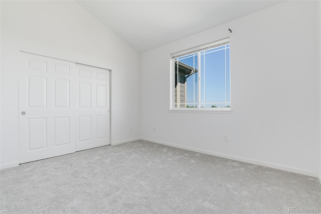 804 Summer Hawk Dr Unit 7301, Longmont, CO 80504 - unfurnished bedroom featuring baseboards, vaulted ceiling, carpet flooring, and a closet