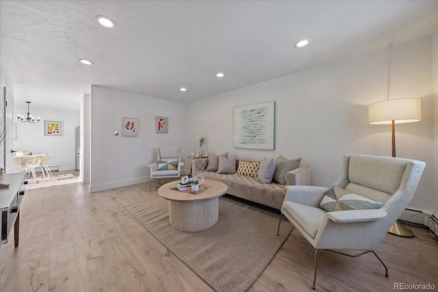 living room featuring light hardwood / wood-style floors and a notable chandelier