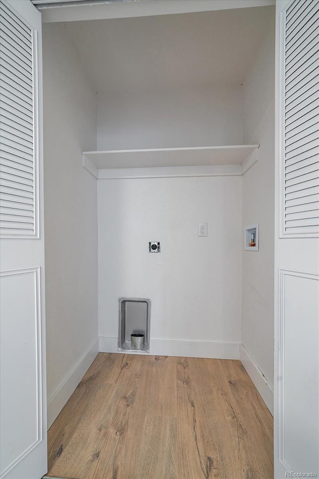 laundry area with washer hookup, light hardwood / wood-style floors, and hookup for an electric dryer