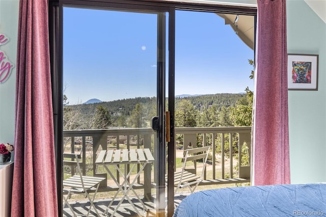 377 Homestead Rd, Bailey, CO 80421 - bedroom with a wooded view, a mountain view, and multiple windows