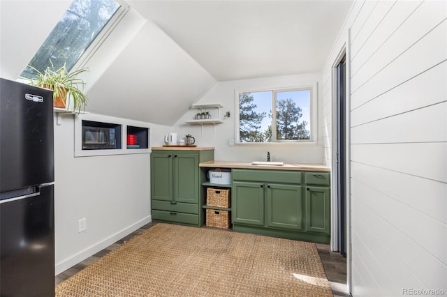 377 Homestead Rd, Bailey, CO 80421 - kitchen featuring green cabinetry, freestanding refrigerator, vaulted ceiling, wood finished floors, and light countertops