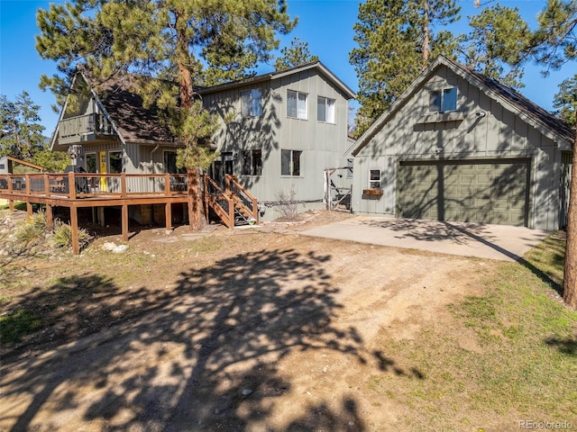 377 Homestead Rd, Bailey, CO 80421 - back of property featuring driveway, a wooden deck, stairway, and board and batten siding