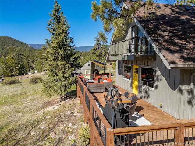377 Homestead Rd, Bailey, CO 80421 - wooden deck with outdoor dining space and a mountain view
