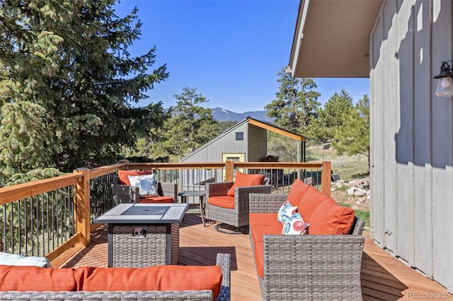 377 Homestead Rd, Bailey, CO 80421 - wooden deck with an outdoor living space with a fire pit, a mountain view, and an outdoor structure