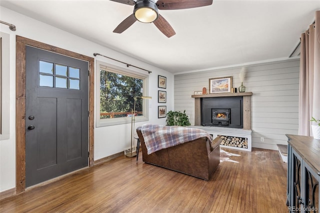 377 Homestead Rd, Bailey, CO 80421 - living room with wood finished floors, ceiling fan, and a warm lit fireplace