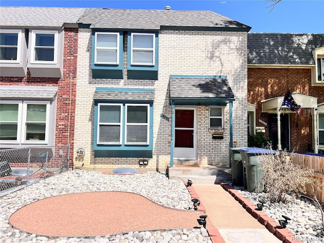11646 Pearl St, Northglenn, CO 80233 - view of property featuring brick siding and a shingled roof