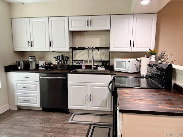 11646 Pearl St, Northglenn, CO 80233 - kitchen with dishwasher, black range with electric cooktop, white microwave, wood counters, and white cabinetry
