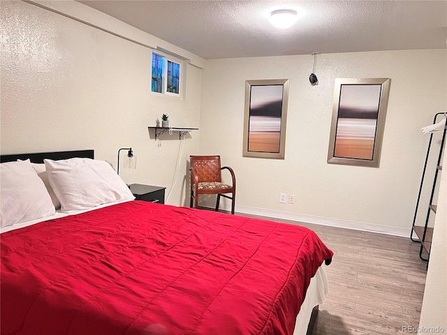 11646 Pearl St, Northglenn, CO 80233 - bedroom featuring wood finished floors and a textured ceiling