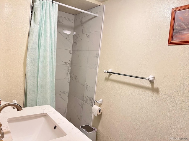 11646 Pearl St, Northglenn, CO 80233 - full bath featuring tiled shower, a textured wall, and vanity