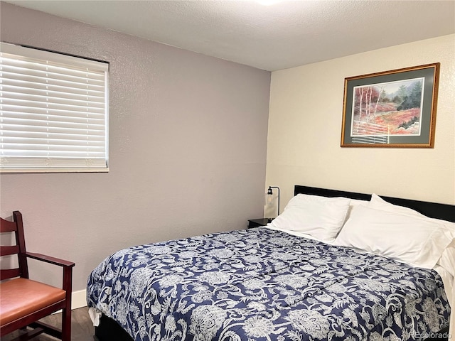 11646 Pearl St, Northglenn, CO 80233 - bedroom with wood finished floors and a textured wall