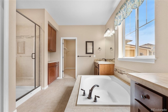 3995 Manorbrier Cir, Castle Rock, CO 80104 - full bath with a shower stall, vanity, a walk in closet, and a garden tub